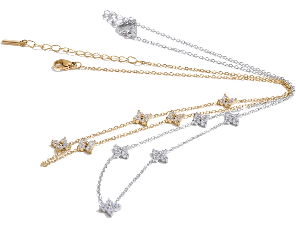 Two necklaces, one gold and one silver, with star-shaped pendants on a white background.