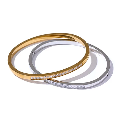 Harriet Bangle — a slim, sparkling line of pavé stones on a sleek stainless steel band. Simple enough for everyday, striking enough to stack. Available in gold or silver.