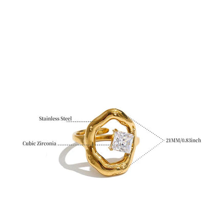A gold-plated cubic zirconia ring with a textured, organic-shaped band on a white background, annotated with text labels pointing to its materials and dimensions, plus a weight specification.