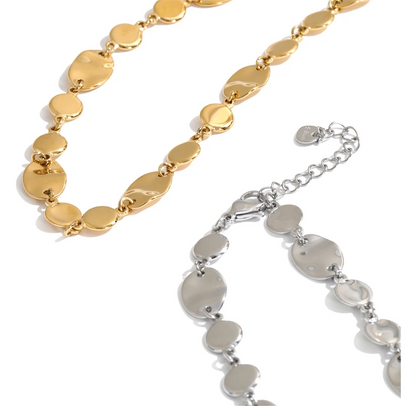 Shop the Jessica Necklace: bold organic disc necklace with a wavy, light-catching finish. Waterproof stainless steel, adjustable fit.