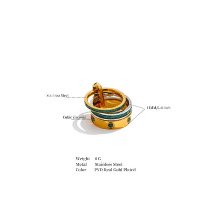 Gold ring with green gemstones on a white background