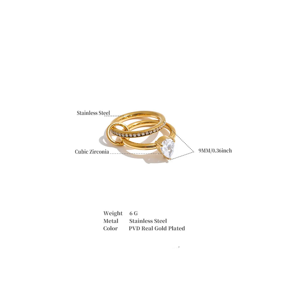 Gold-plated stainless steel and cubic zirconia ring set with a large clear center stone, shown on a white background with product labels and specifications text below.
