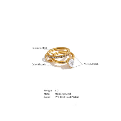Gold-plated stainless steel and cubic zirconia ring set with a large clear center stone, shown on a white background with product labels and specifications text below.