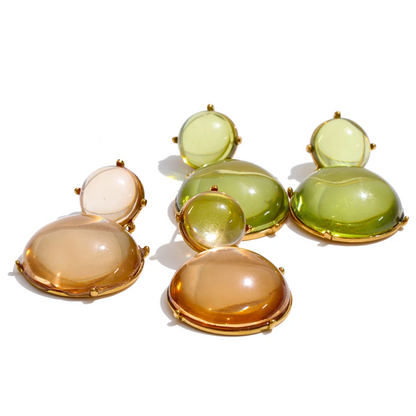 Pair of earrings with large, round, multicolored stones on a white background