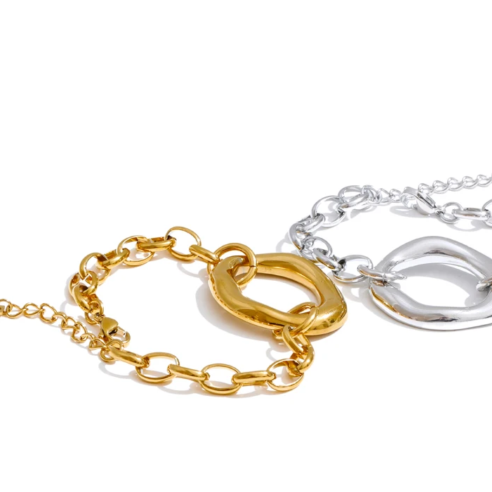 Two chunky chain bracelets with oversized oval links, one in polished gold and one in polished silver, displayed on a clean white background.