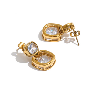 Shop the Sophie Earrings: modern drop studs with stacked cushion-cut zircons. Waterproof, hypoallergenic stainless steel in 18k gold-tone.
