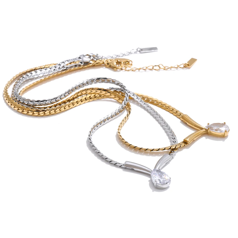 Whitney Necklace – sleek herringbone chain with a pear zircon pendant. Tarnish-free stainless steel, silver or gold. Adjustable fit.